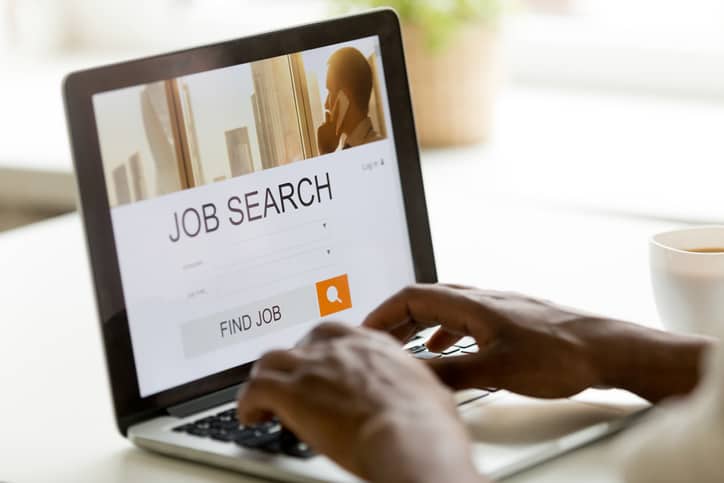 man browsing work online using job search computer app