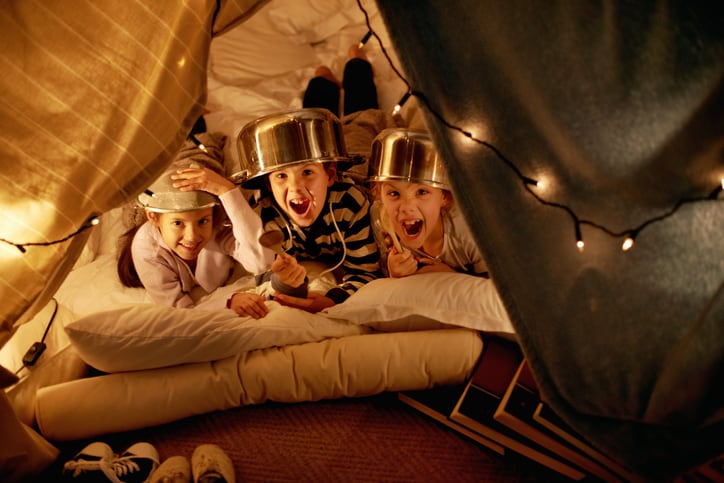 kids playing in a blanket fort