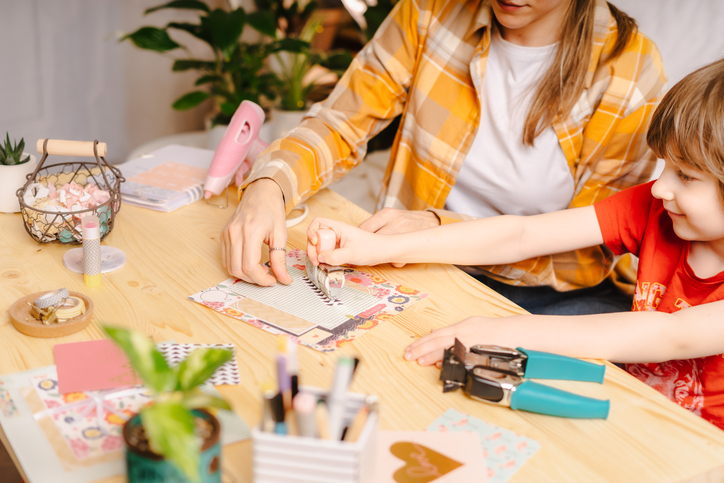 woman and child making a scrapbook together