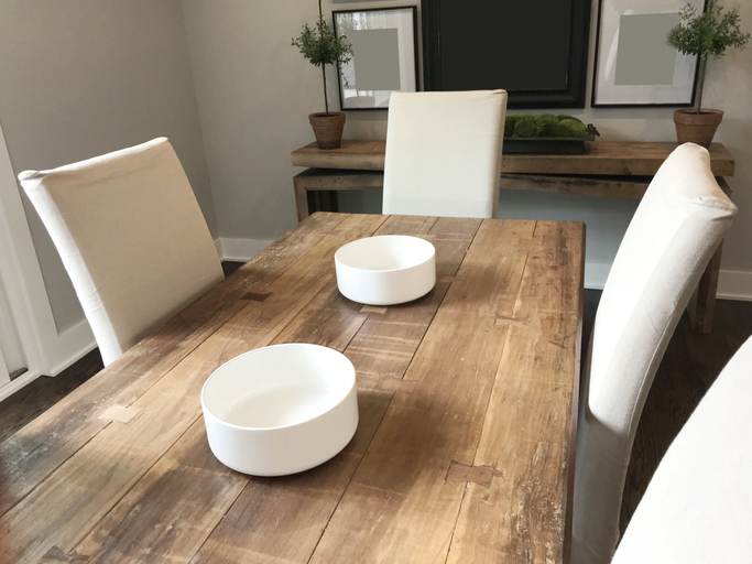 Farmhouse chic decor dining table with bowls as the centerpiece on a long wooden table