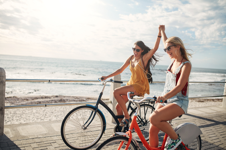 Female friends enjoying cycling on a summer day