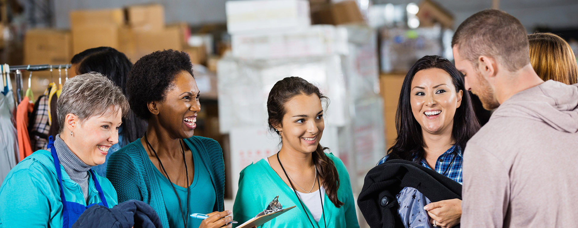 Goodwill AZ | Group of people smiling in a wearhouse