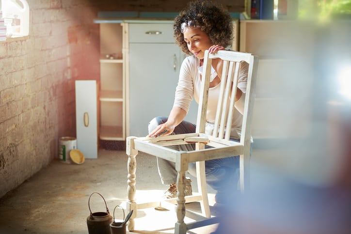 Goodwill AZ | Women sanding down a chair
