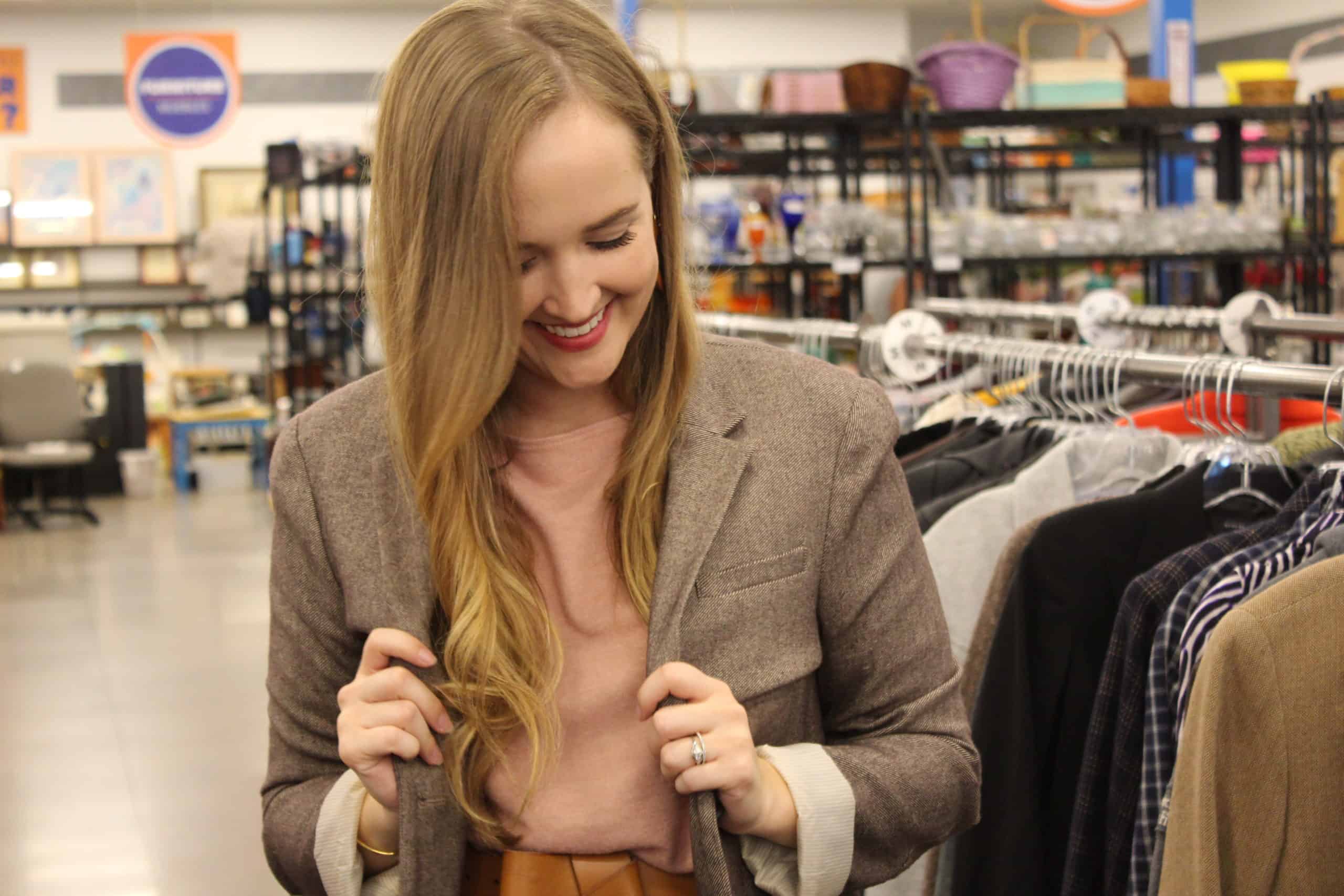 Goodwill AZ | Someone looking through racks of white shirts on hangers