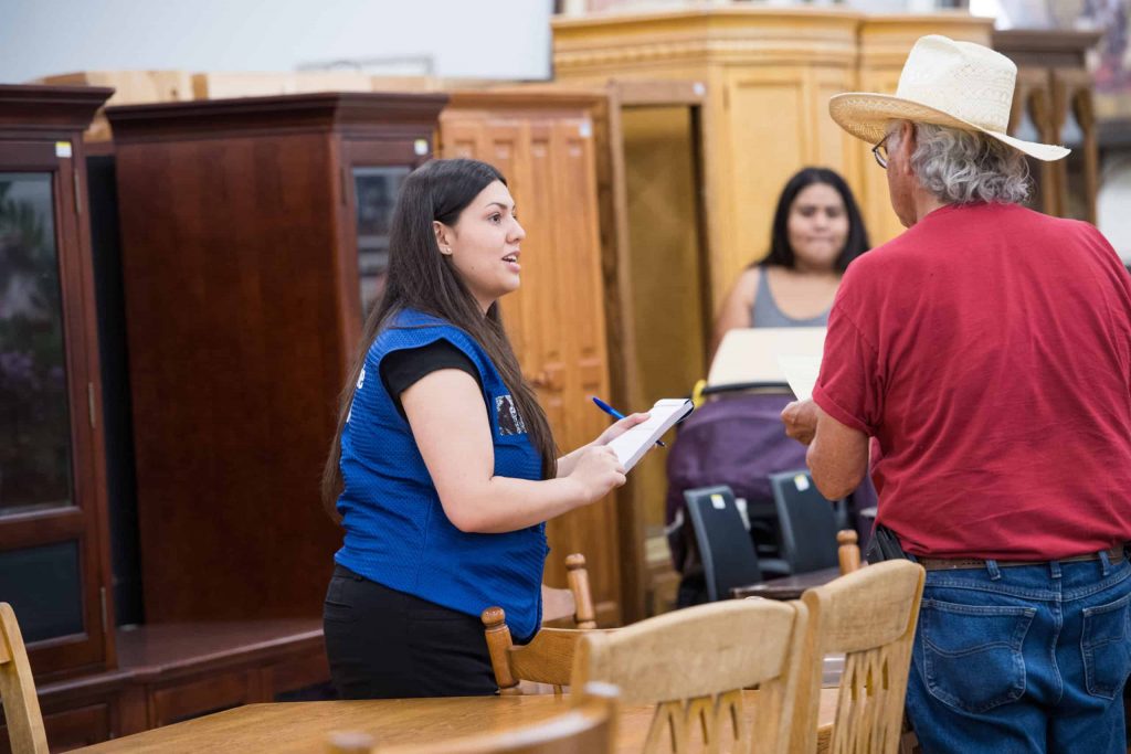 Goodwill AZ | Women talking to a man in hat