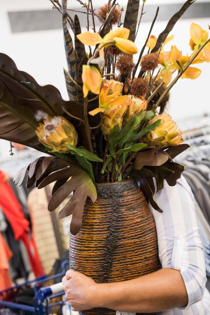 Goodwill AZ | Someone holding a vase with flowers