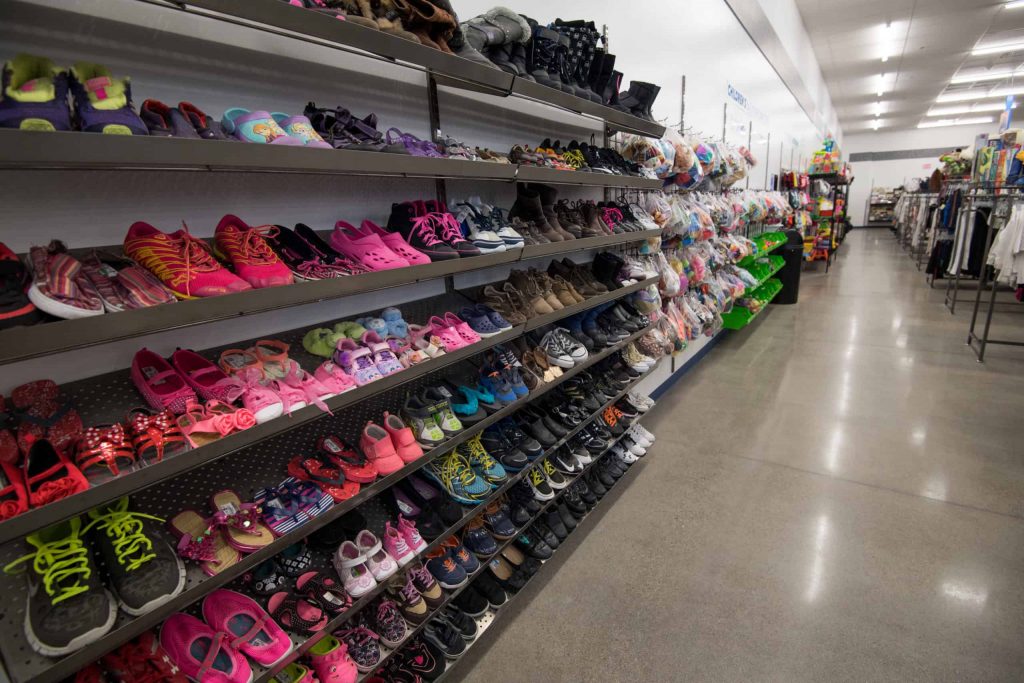 Goodwill AZ | Racks of childrens shoes in a store