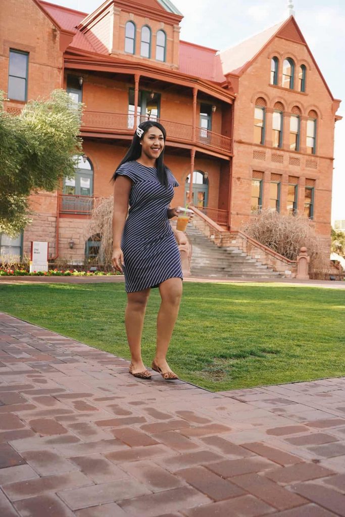 Goodwill AZ | Woman walking in front of a red brick building