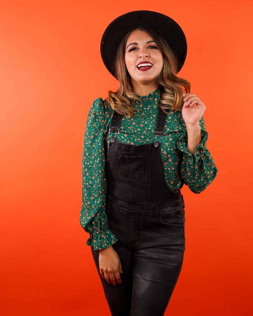 Goodwill AZ | Women in black overalls and floral shirt