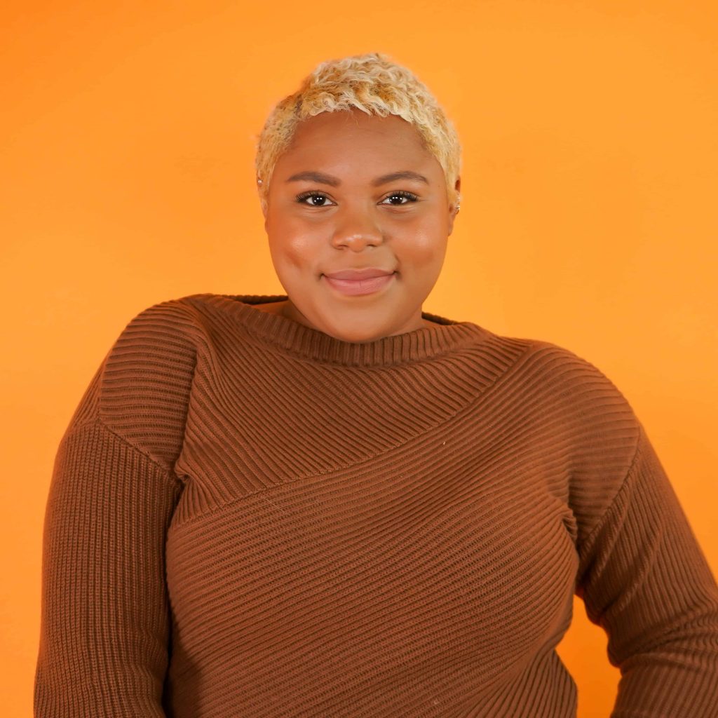 Goodwill AZ | Women in tan sweater smiling