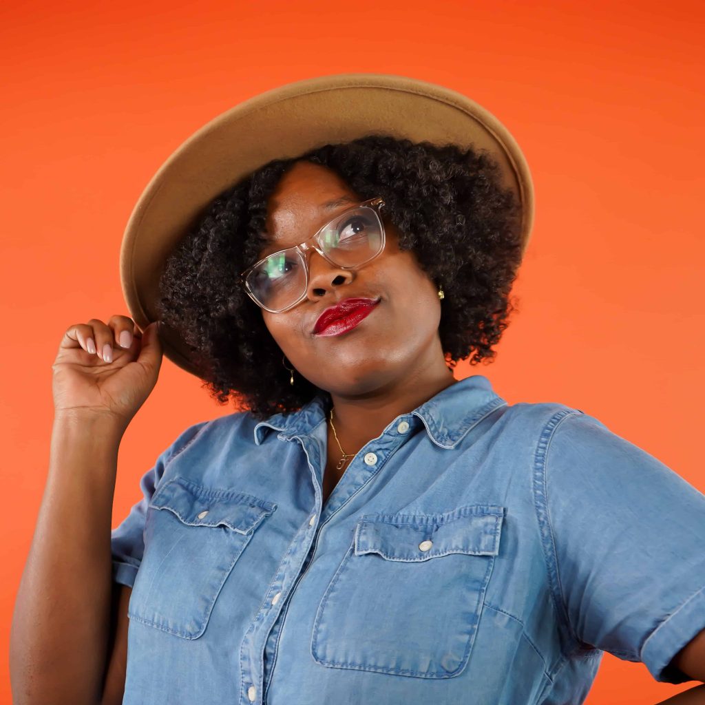 Goodwill AZ | Women in denim shirt and tan hat