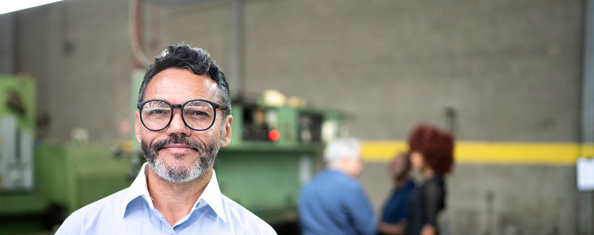 Goodwill AZ | Man in glasses standing in a wearhouse
