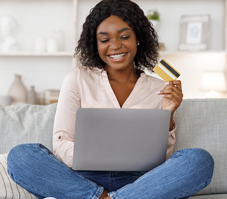 Goodwill AZ | Women holding a credit card and laptop