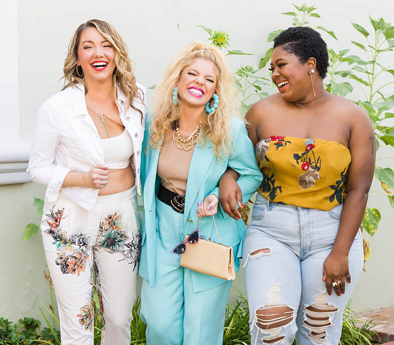 Goodwill AZ | Three women in floral prints smiling outside