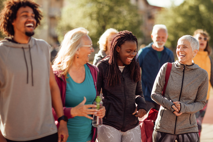 Smiling group of people walking together outdoors | Charity Shop | Goodwill AZ