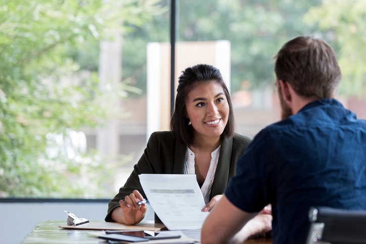 woman engaging in a mock interview with man