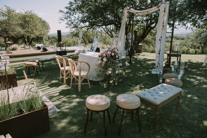 Thrifted wedding decor; Table with white tablecloth, wooden plates and candles