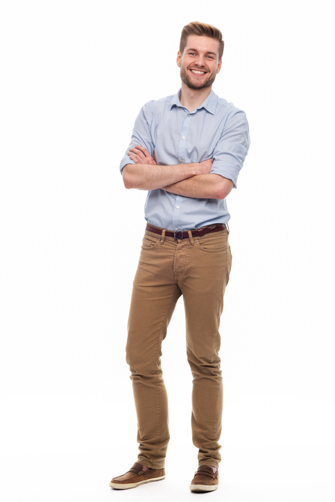 man standing with his arms crossed wearing button down shirt and khakis
