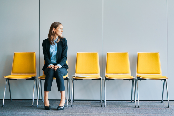 Businesswoman waiting for job interview in black pant suit