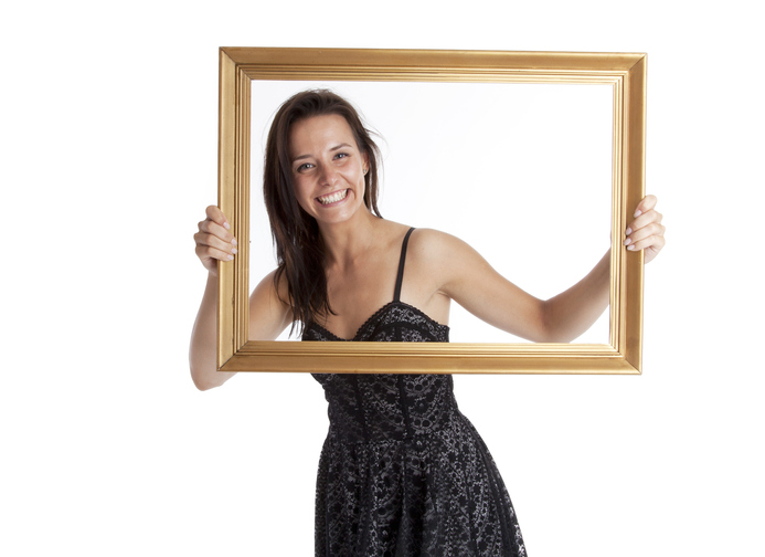 woman holding up picture frame