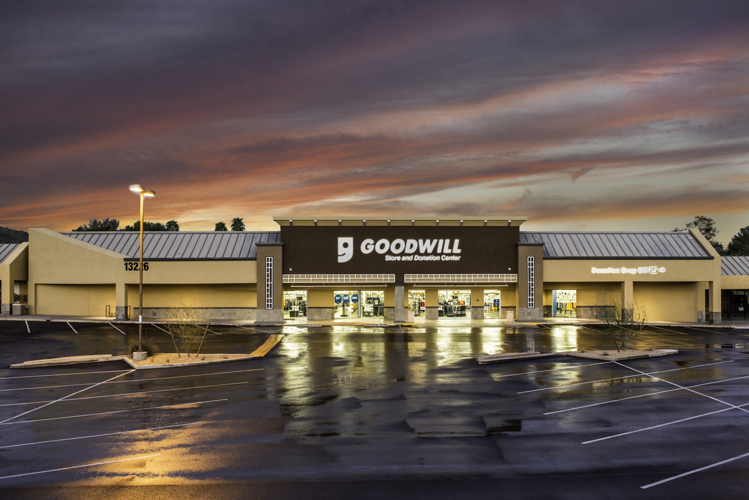 Goodwill AZ | Someone looking through racks of white shirts on hangers