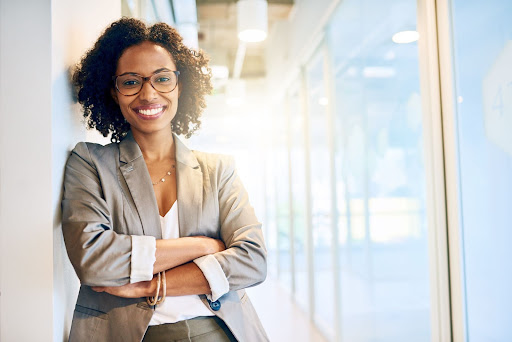 Woman leaning against wall smiling at the camera