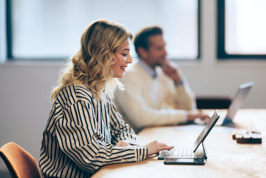 Man and woman using technology at work