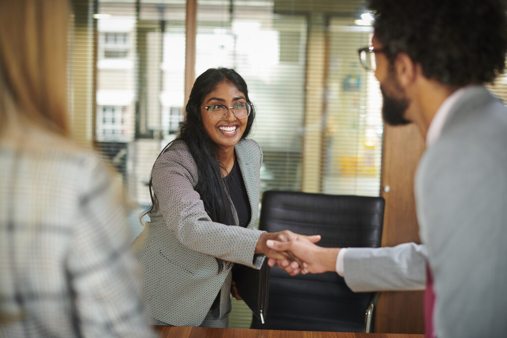 Girl arriving to her interview shaking hands