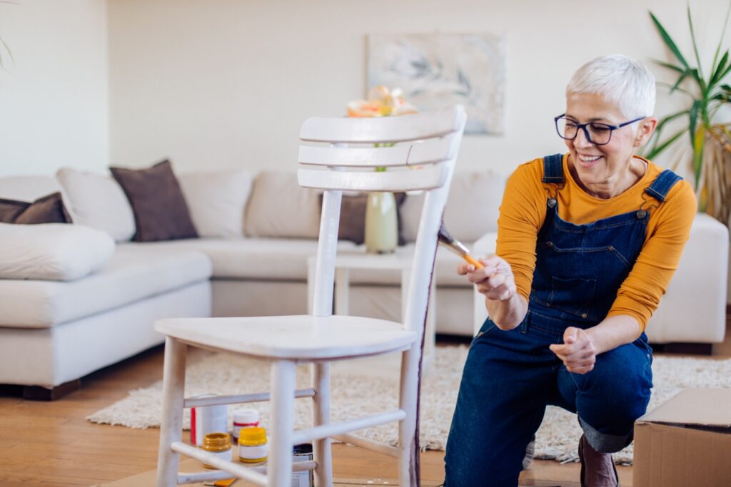 woman painting her chair