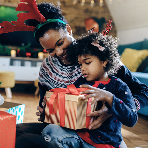 Mom and son sitting together with presents