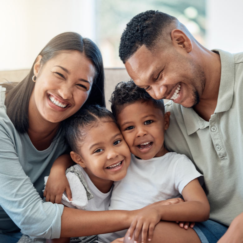A family sitting down smiling