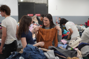 Two women shopping the bins at the Goodwill Clearance Center
