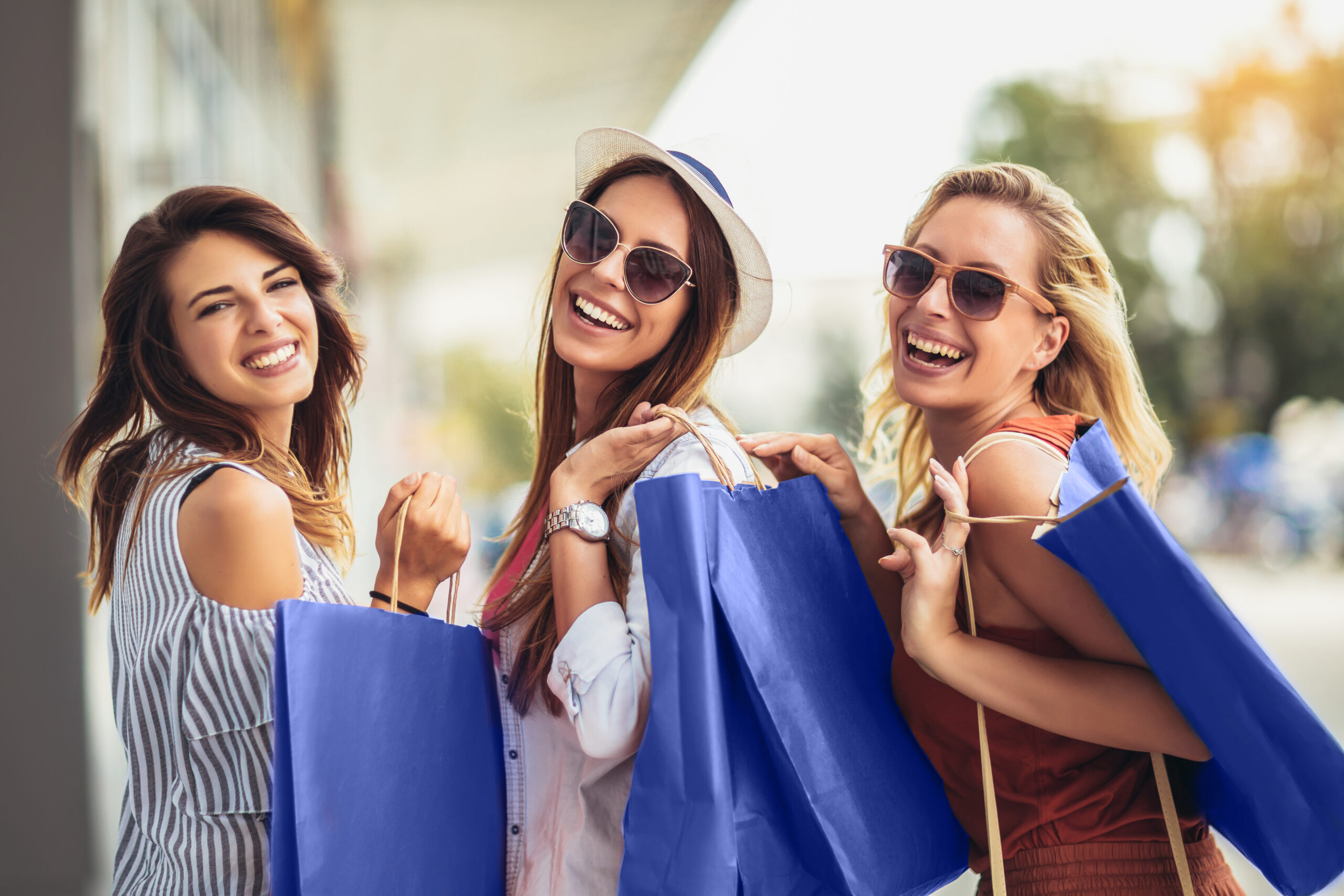 Goodwill AZ | Someone looking through racks of white shirts on hangers