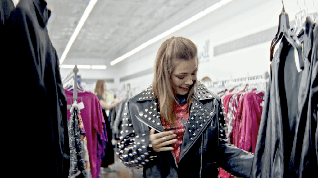 A young girl wearing a leather vintage jacket