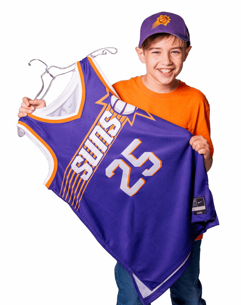A young boy holding a sun jersey