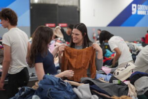 Two women look through clothing at the Goodwill Clearance Center