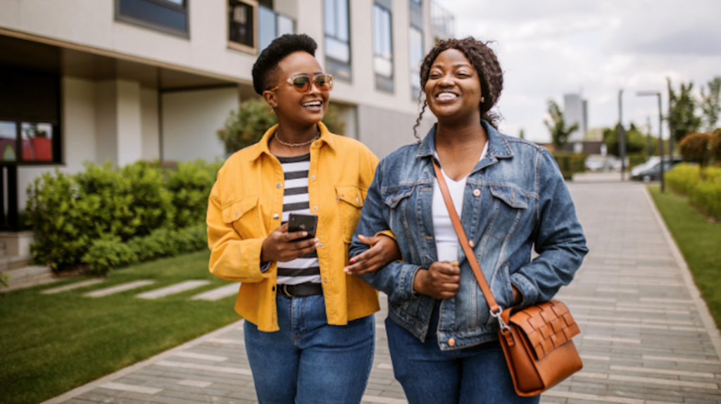 Two women walking outside with layered clothing on