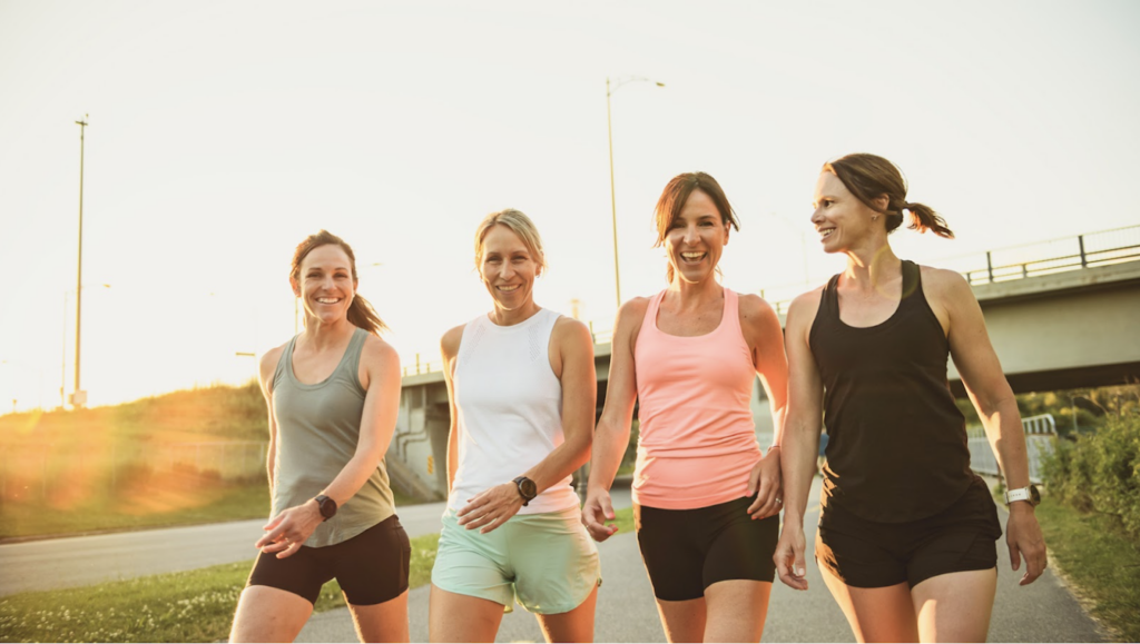 A group of women walking outside in activewear
