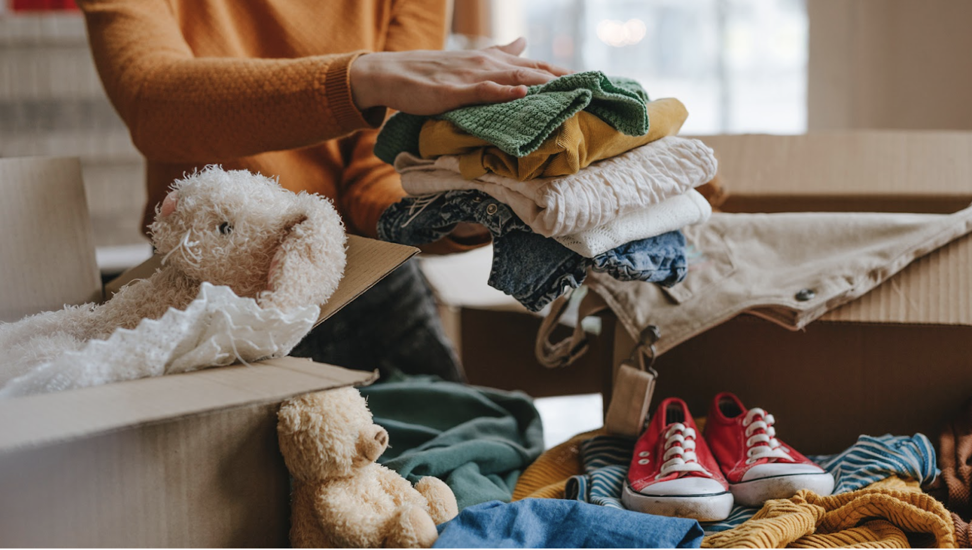 Goodwill AZ | Someone looking through racks of white shirts on hangers