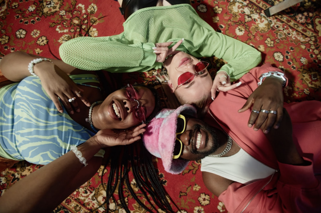 Three girls laying on a run wearing Y2K fashion