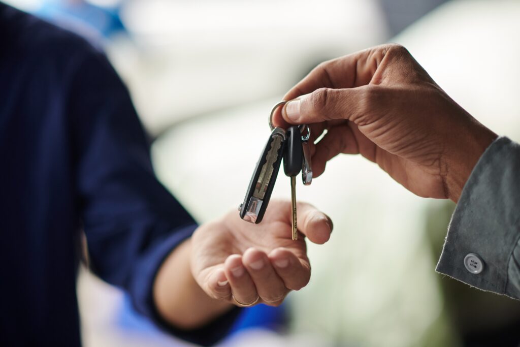 Someone handing over keys to someone else