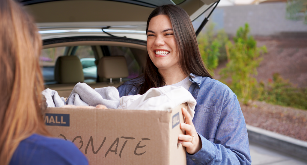 A women handing over a donation box