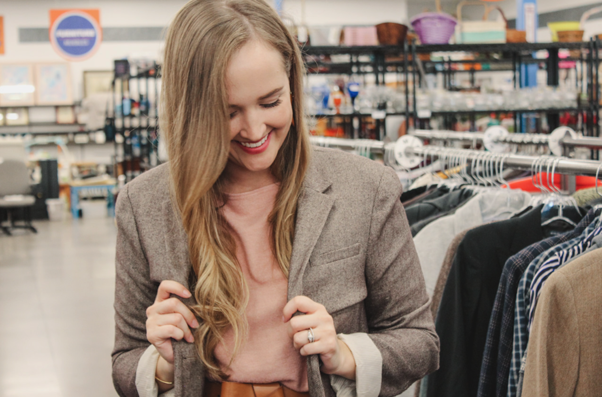 Goodwill AZ | Someone looking through racks of white shirts on hangers