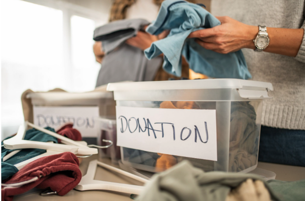 A couple filling a bin with donations to take to their local Goodwill
