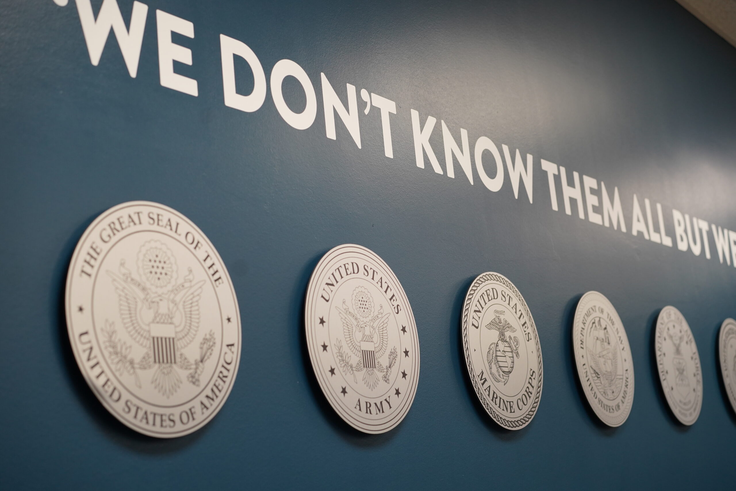 Multiple military seals on a wall