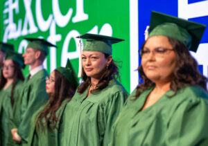 Excel Center graduates standing at graduation ceremony